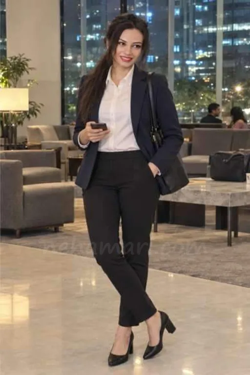 Emily in a navy blazer and white shirt in a business hotel lobby in Whitefield